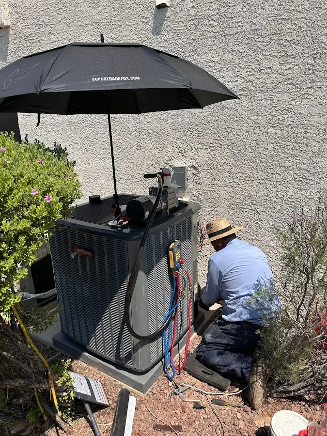 HVAC technician performing outdoor AC maintenance in Rockwood